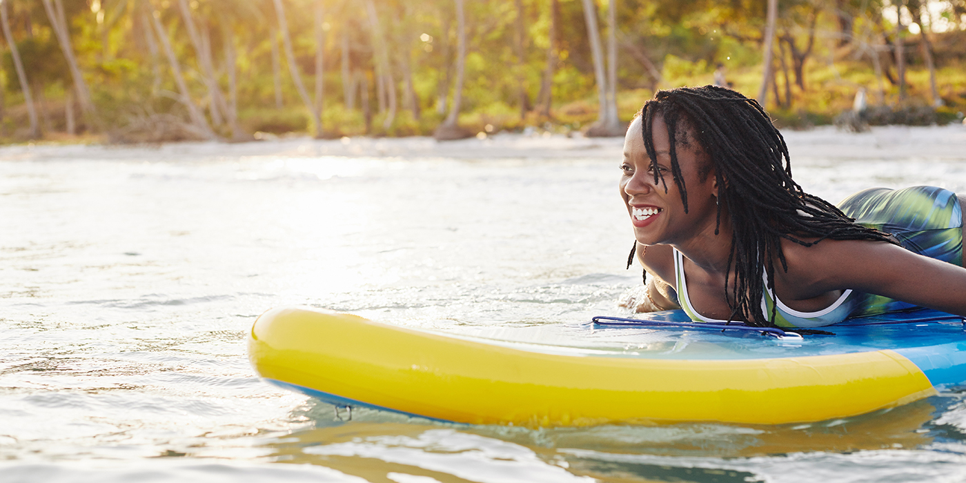Woman swimming on sup board