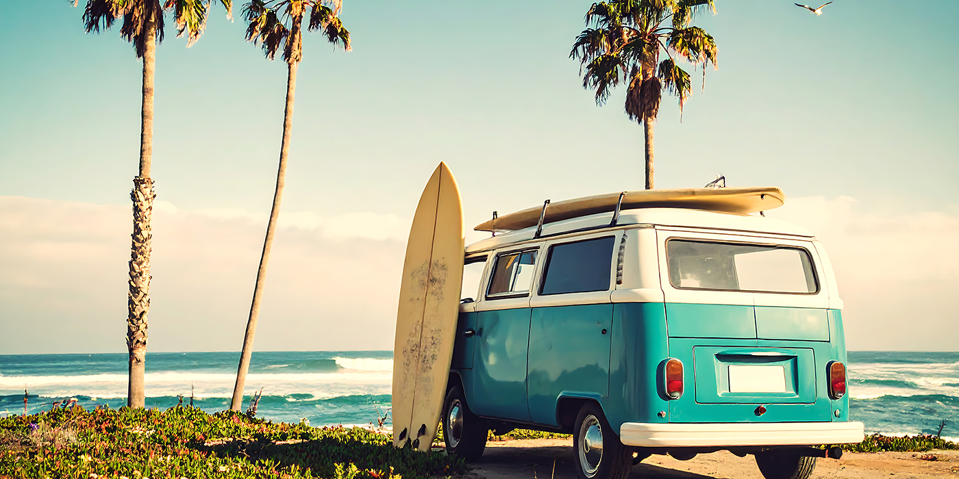 Retro van on beach with surfboards