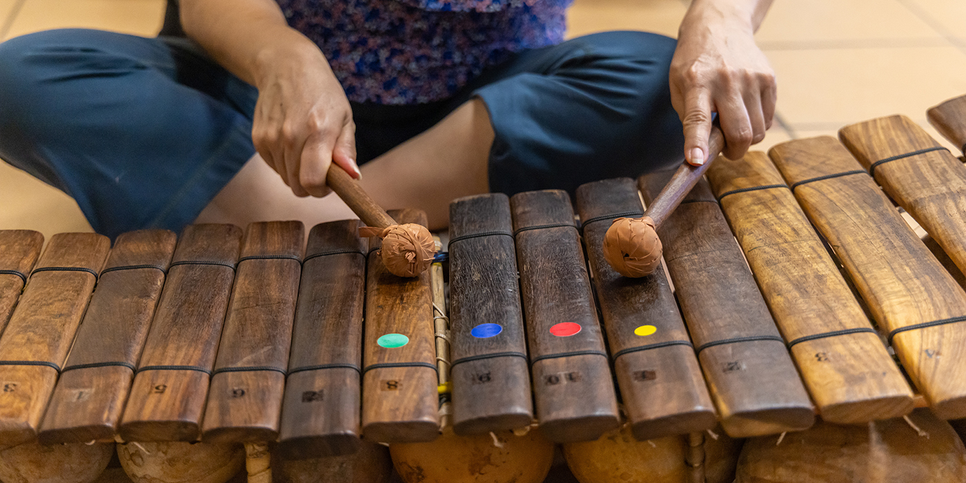 Musician playing traditional wooden xylophone with mallets