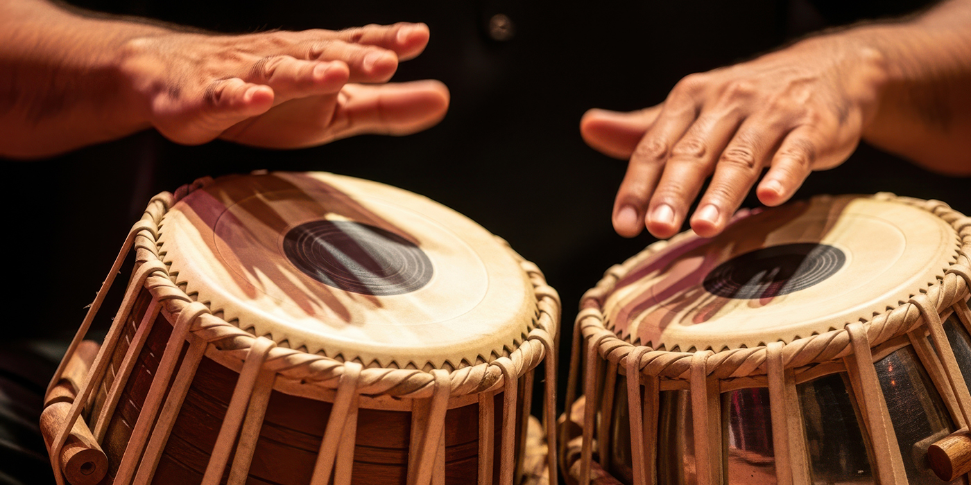 Close-up of hands playing traditional Indian tabla drums