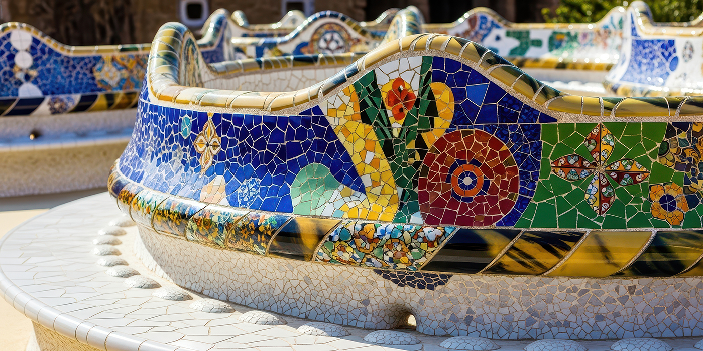 Vibrant mosaic benches in a sunny park with intricate tile work