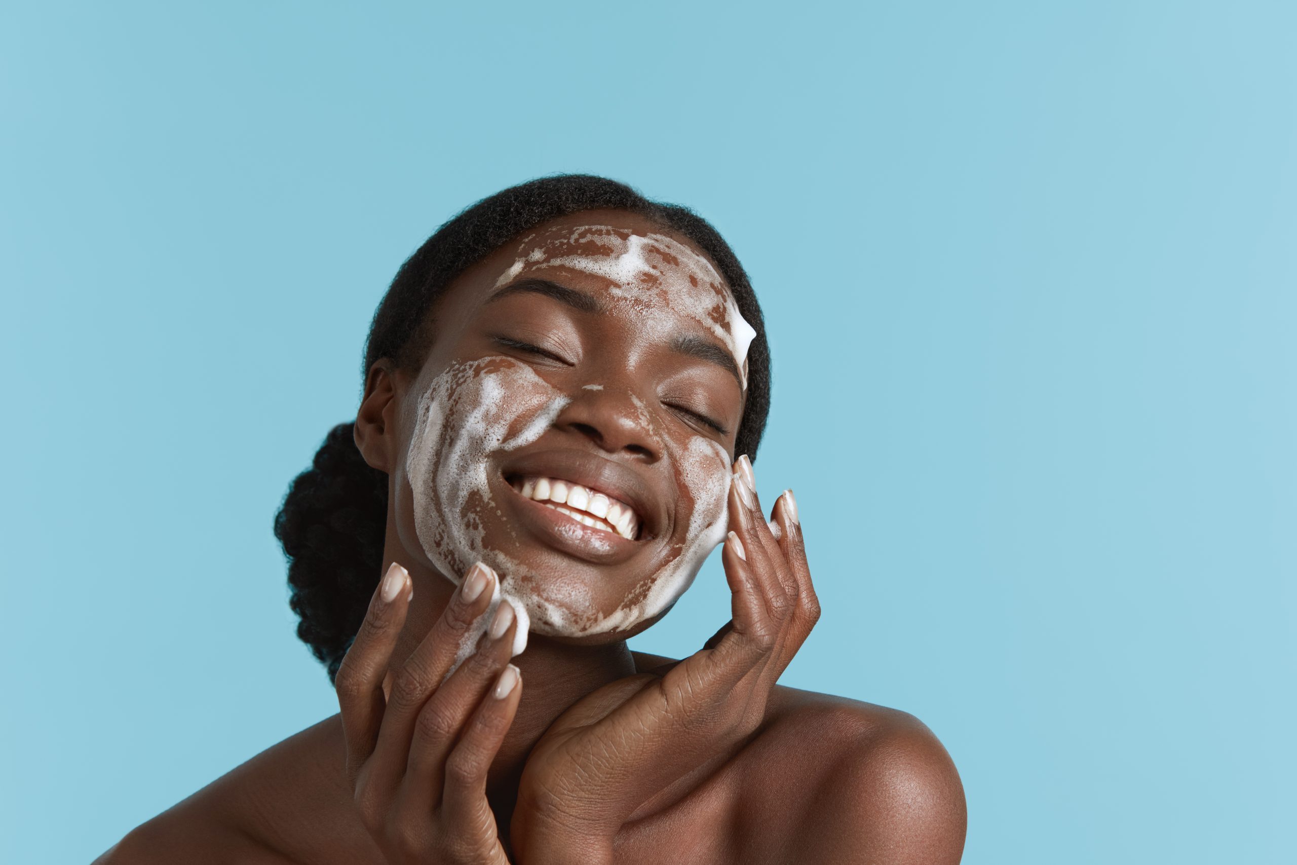 Black girl wash face with cleansing face foam