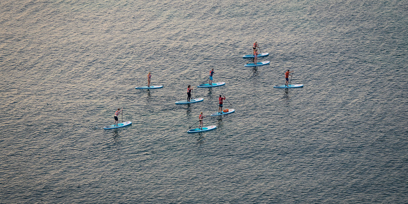 Paddleboarding or stand up paddle class in the coastline of Lago