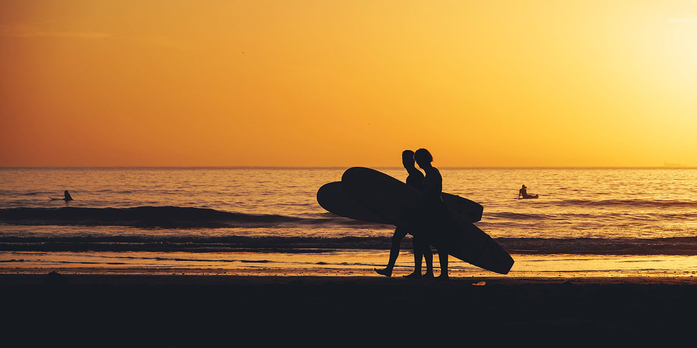 Surfers during sunset in Taghazout, Morocco