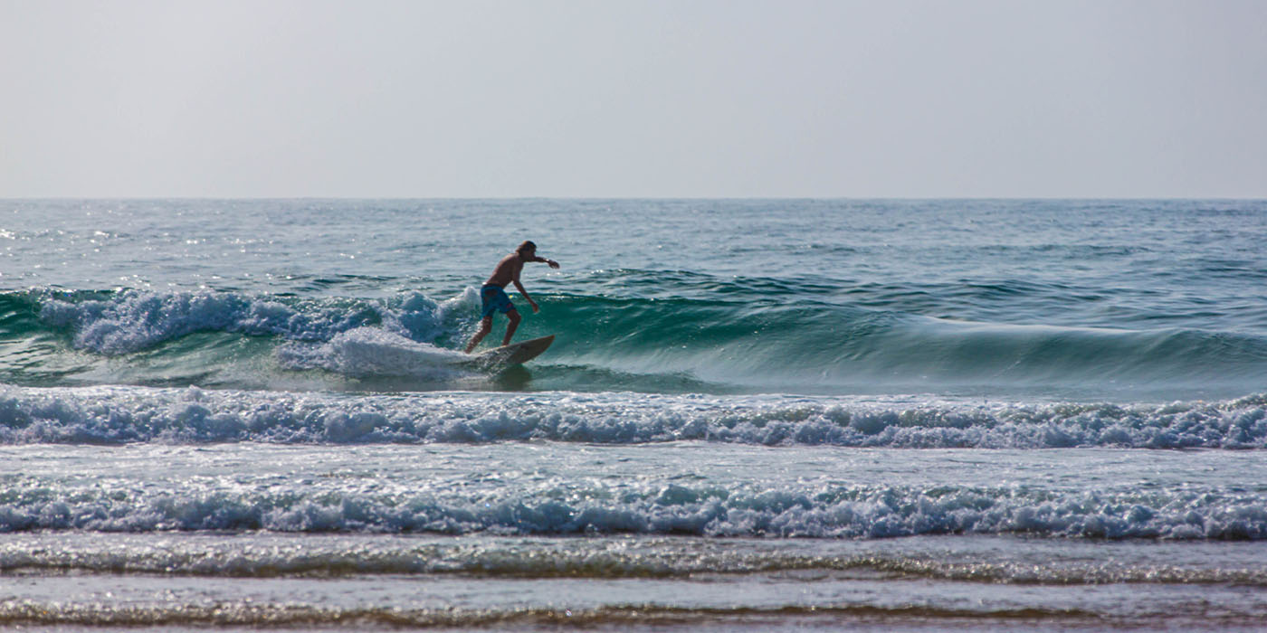 A man is surfing on a surfboard in Agadir beach