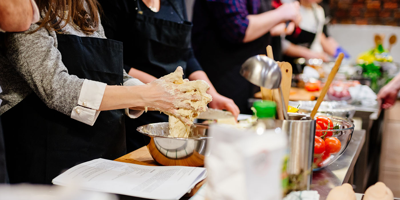 Woman preparing dough in the bowl.